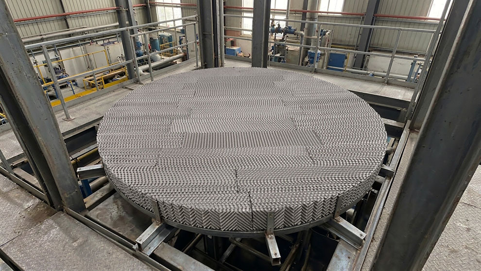 Structured packing elements installed inside a distillation column with liquid distributor above
